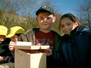 Children holding home made bird nest box